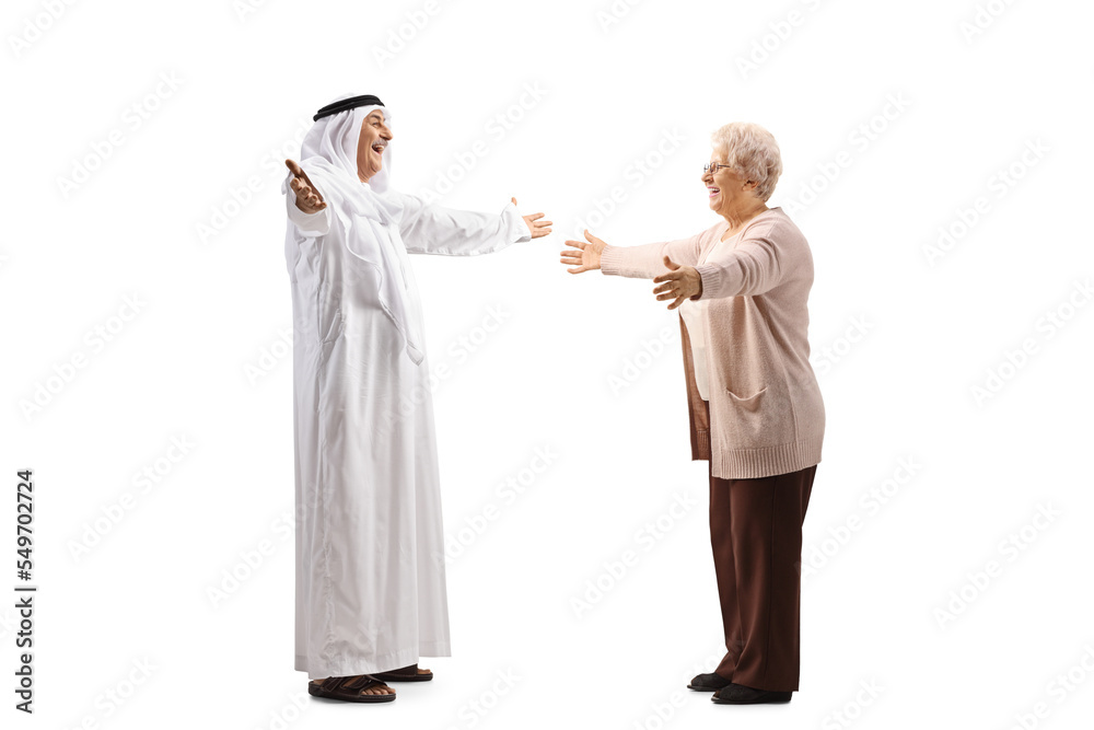 Full length profile shot of a mature arab man in a robe greeting an elderly lady Full length profile shot of a mature arab man in a robe greeting an elderly lady