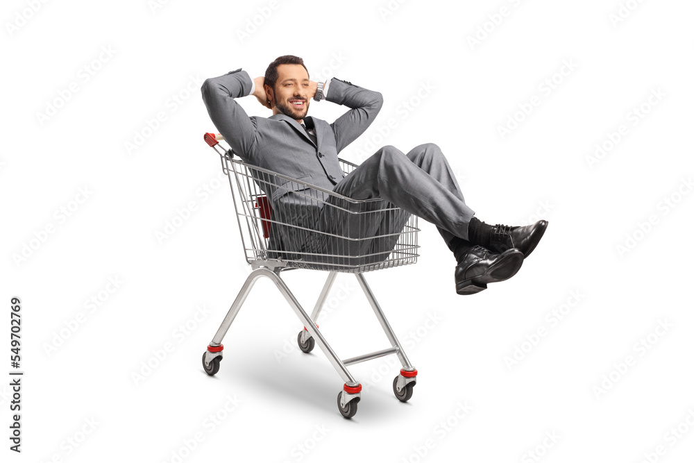 Businessman sitting and resting inside a shopping cart Businessman sitting and resting inside a shopping cart