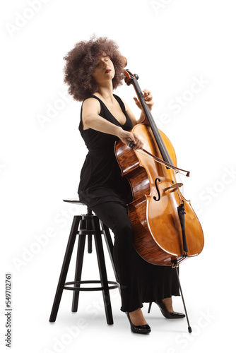 Woman in a black dress sitting on a chair and playing a cello