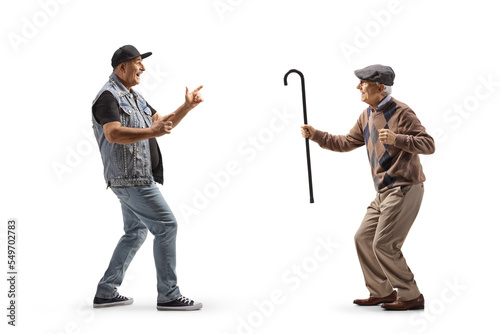 Full length profile shot of a cool mature man dancing with an elderly man