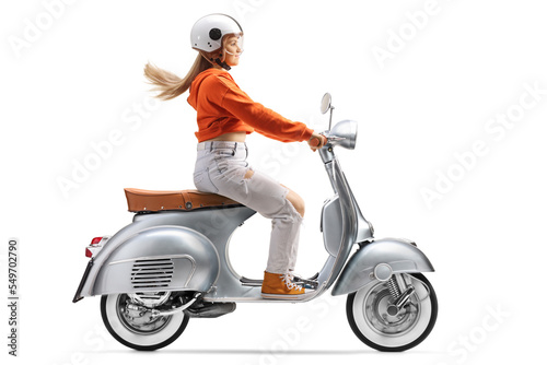 Young female with a helmet riding a scooter