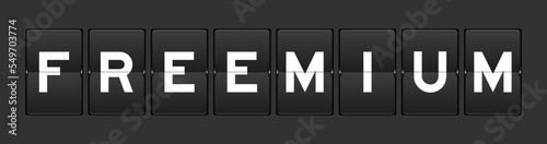 Black color analog flip board with word freeemium on gray background