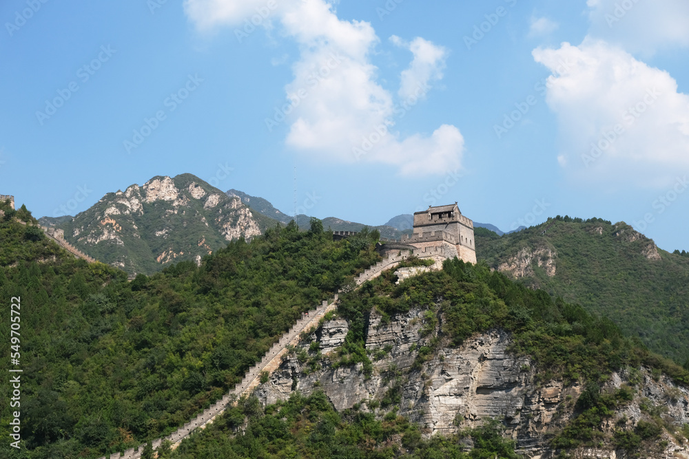 one section of the Great Wall at Juyong Pass in Beijing on sunny day with blue sky white clouds