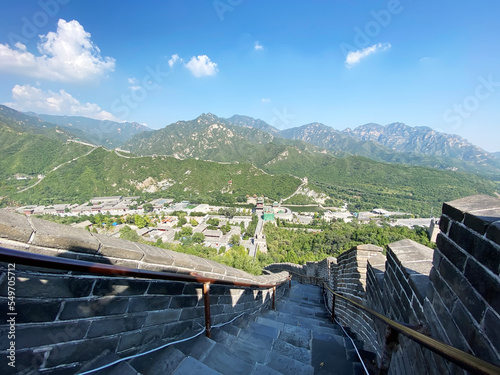 high angle view of the Great Wall and steps at Juyong Pass in Beijing on sunny day with blue sky white clouds photo