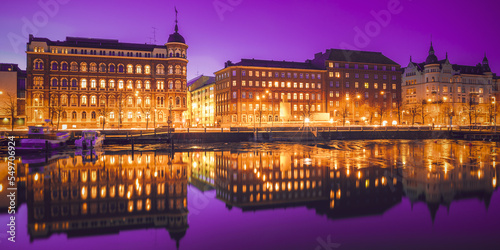 Helsinki, Finland. Very Peri Starry Sky. View Of Pohjoisranta Street In Evening Or Night Illumination. Bright Dramatic Light Purple Sky.