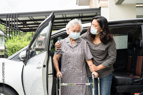 Help and support asian senior or elderly old lady woman patient walk with walker prepare get to her car, healthy strong medical concept.