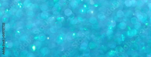 Blurred blue and turquoise sparkling background from small sequins, macro. Cerulean defocused backdrop