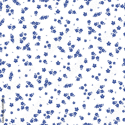 Cute floral pattern. Seamless vector texture. An elegant template for fashionable prints. Print with small blue flowers and leaves. white background.