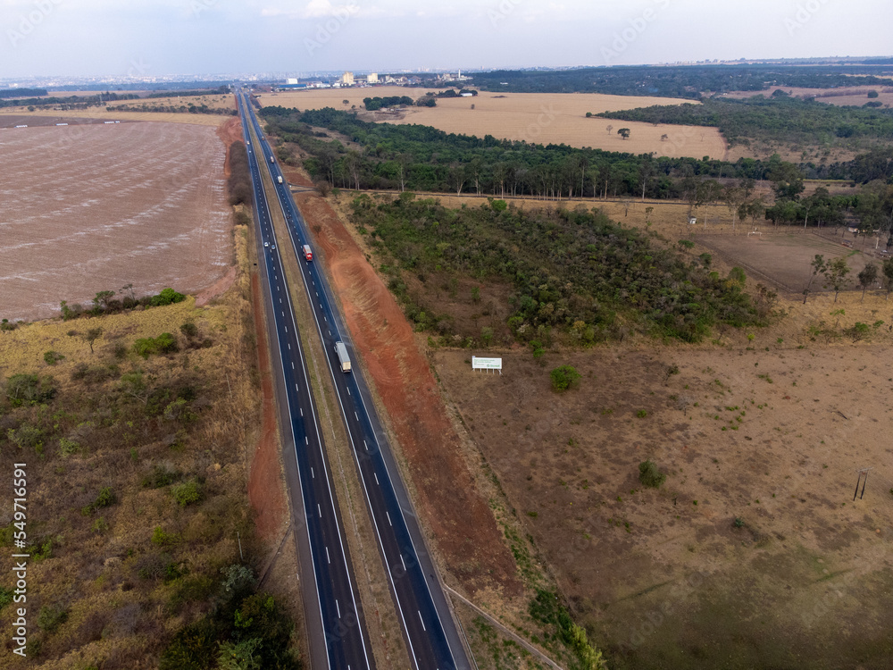 large highway in dry grass scenery amidst the farms