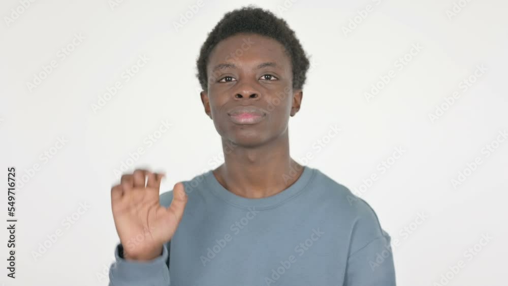 Young African Man Waving Hand to Say Hello on White Background 