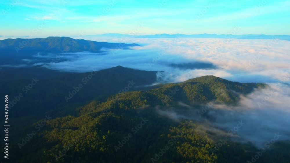Aerial view over dense fog and beautiful mountains during sunrise. landscape of tropical rainforest in winter. Pai District, Mae Hong Son Province, Northern Thailand. travel and nature concept. 4K
Aerial view over dense fog and beautiful mountains during sunrise. landscape of tropical rainforest in winter. Pai District, Mae Hong Son Province, Northern Thailand. travel and nature concept. 4K