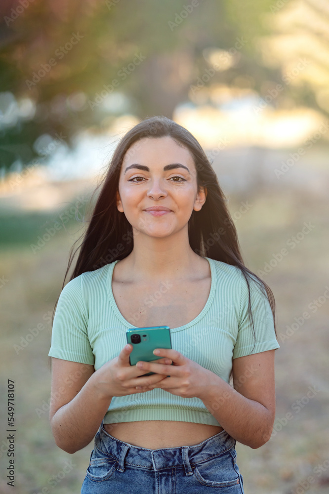 Beautiful brunette girl iusing smart phone Beautiful brunette girl iusing smart phone
