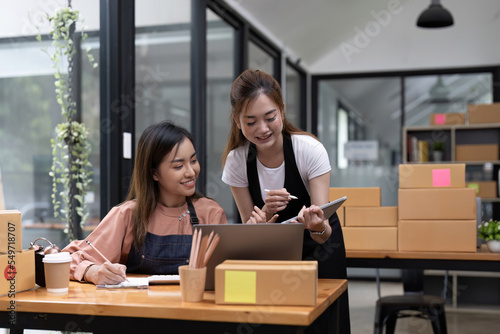 Two Asian woman working together for SME project. Young Owner people startup for Business Online, SME, Delivery Project. Online Business and Small business Concept