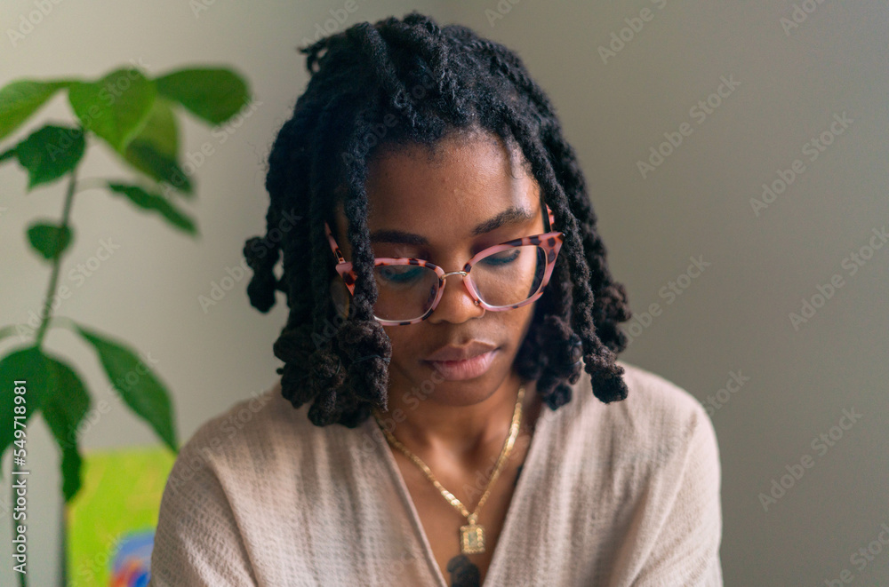Young woman with locs intentionally making flower infused herbal bath Young woman with locs intentionally making flower infused herbal bath