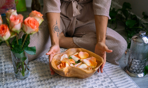 Young woman presenting flower infused herbal bath