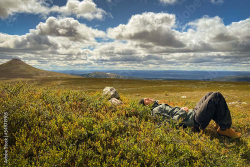 Man resting on hiking trip. Nipfjället nature reserve. Mountains in Idre, Sweden.