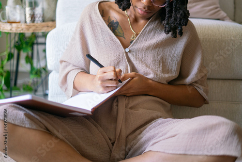 Young woman journaling in her home