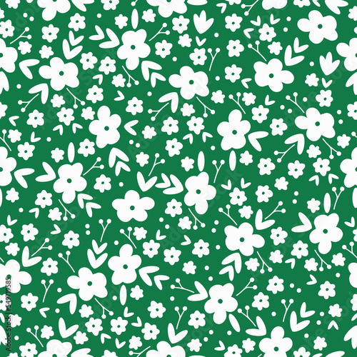 Cute floral pattern. Seamless vector texture. An elegant template for fashionable prints. Print with white flowers leaves  and dots. green background.