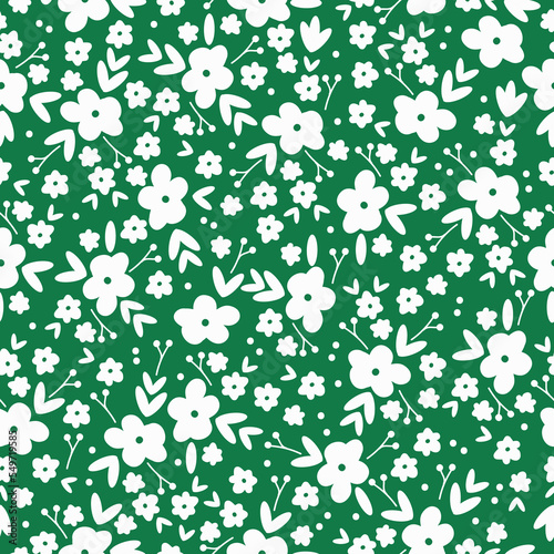 Cute floral pattern. Seamless vector texture. An elegant template for fashionable prints. Print with white flowers,leaves  and dots. green background.
