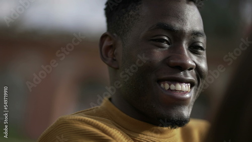 Happy black African man smiling and laughing portrait face close-up