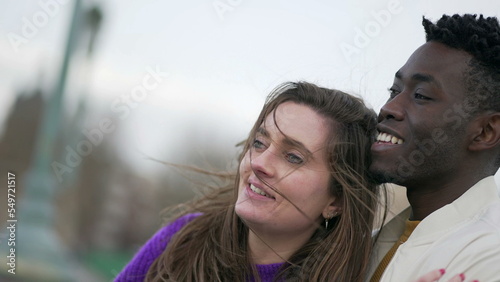 Diversity concept, young interracial couple standing together outside