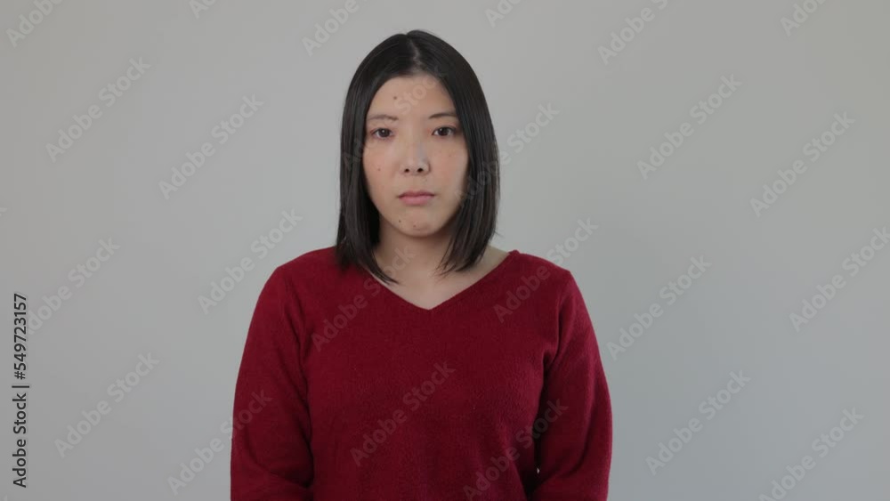Young Japanese woman opens her eyes and stares the camera. Emotionless, Still, Protest. Young Japanese woman opens her eyes and stares the camera. Emotionless, Still, Protest.