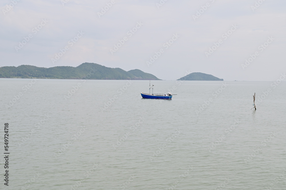 CHANTABURI, THAILAND - November 20, 2022 : Many small fishing boats floating in the sea with blue sky background in Thailand.