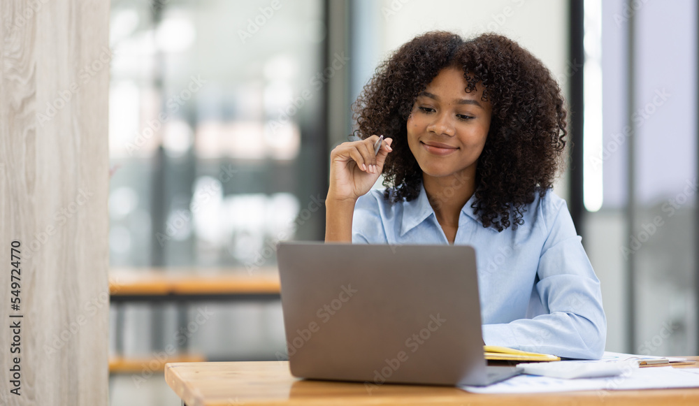 Successful african american accountant business woman work documents tax on laptop computer in office. finance investment economy and marketing research concept. Successful african american accountant business woman work documents tax on laptop computer in office. finance investment economy and marketing research concept.