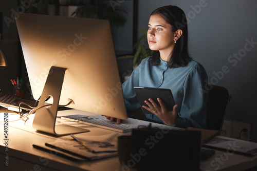 Night office, computer and business woman with tablet for digital marketing, seo analytics and multimedia application review. Website design, graphic designer and creative employee in dark workspace photo
