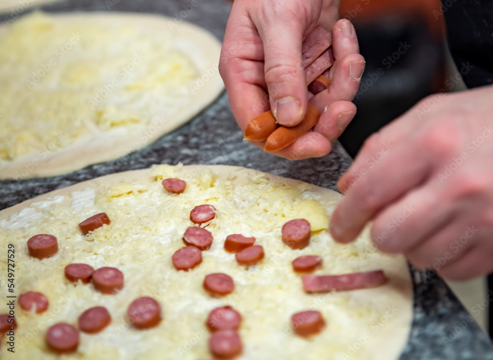 Closeup hand of chef baker making pizza at kitchen. The process of making pizza. cooking italian pizza