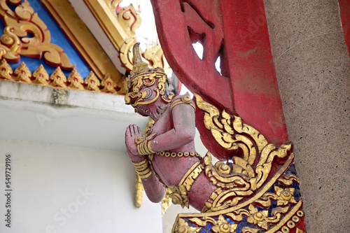 Closeup of Colorful Garuda Statue on the top of the pole in the temple at bangkok, Thailand.