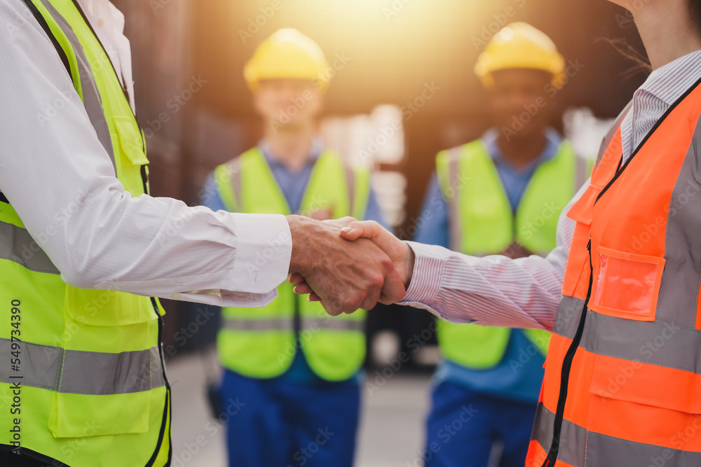 Caucasian business managers and worker team is meeting do shake hands on a large commercial tracking inventory, close up. Business Partnership Greeting Handshaking to seal the deal After Discussion. Caucasian business managers and worker team is meeting do shake hands on a large commercial tracking inventory, close up. Business Partnership Greeting Handshaking to seal the deal After Discussion.