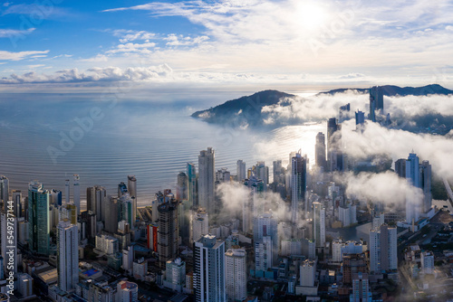 Aerial view of mist covering the city of Bal. Camboriú early morning, Brazil. photo