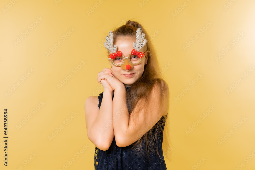 Portrait of a teenage girl in funny glasses. Christmas. celebration
