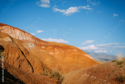 Scenic view of red sandstone, cliffs and rocky mountains under a blue sky. Wild natural landscape.