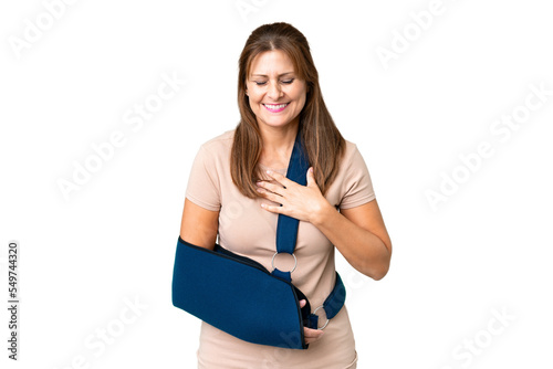 Middle age with broken arm and wearing a sling over isolated background smiling a lot