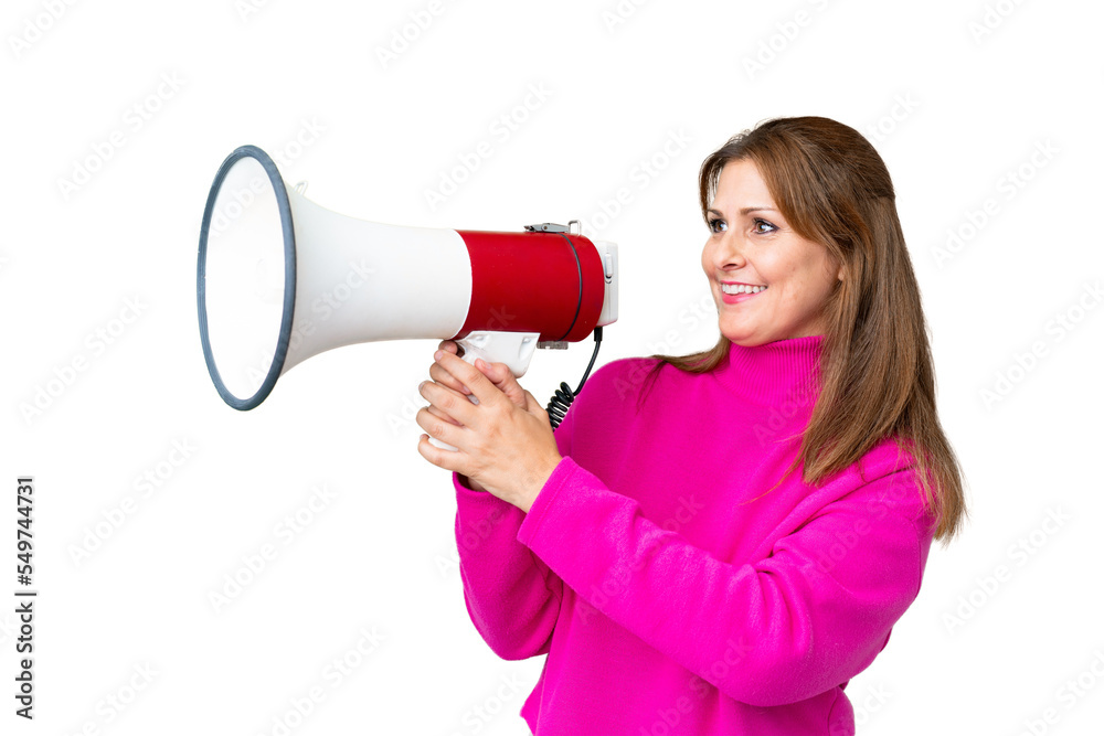 Middle age woman over isolated background shouting through a megaphone to announce something Middle age woman over isolated background shouting through a megaphone to announce something