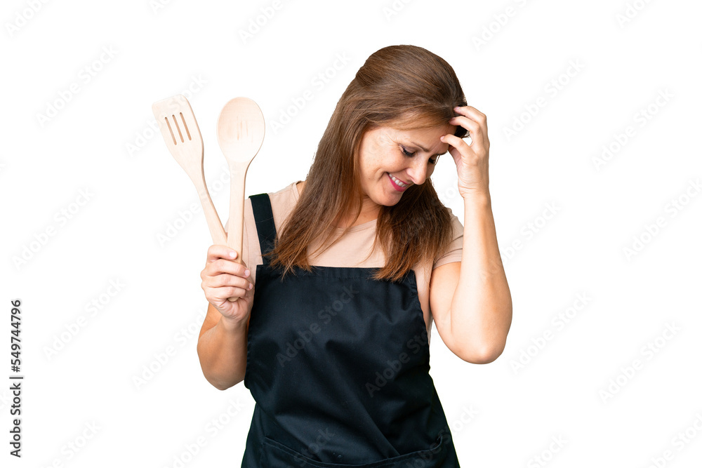 Middle age caucasian woman holding a rolling pin over isolated background laughing Middle age caucasian woman holding a rolling pin over isolated background laughing
