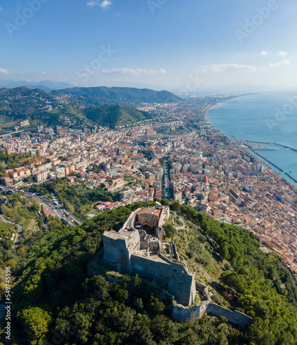 Panoramic aerial view of Arechi Castle on mountain top with Salerno downtown in background, Salerno, Campania, Italy.