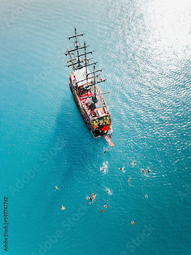 Kemer, Turkey - 13 October 2022: Aerial view of Pirate ship crew swimming. photo