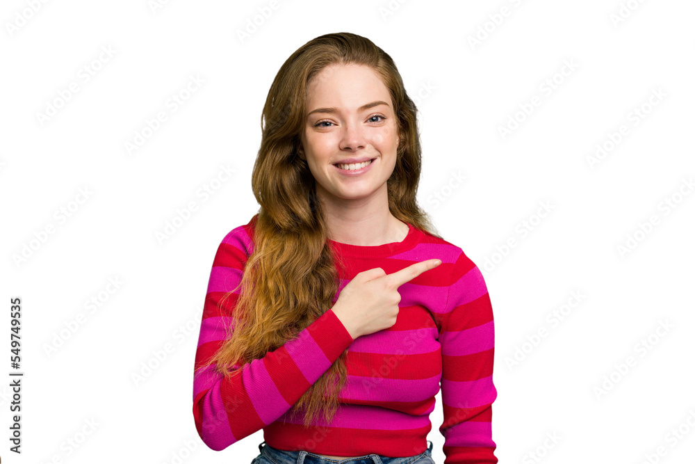 Young caucasian redhead woman isolated smiling and pointing aside, showing something at blank space. Young caucasian redhead woman isolated smiling and pointing aside, showing something at blank space.