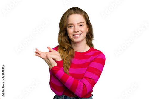 Young caucasian redhead woman isolated holding a copy space on a palm.