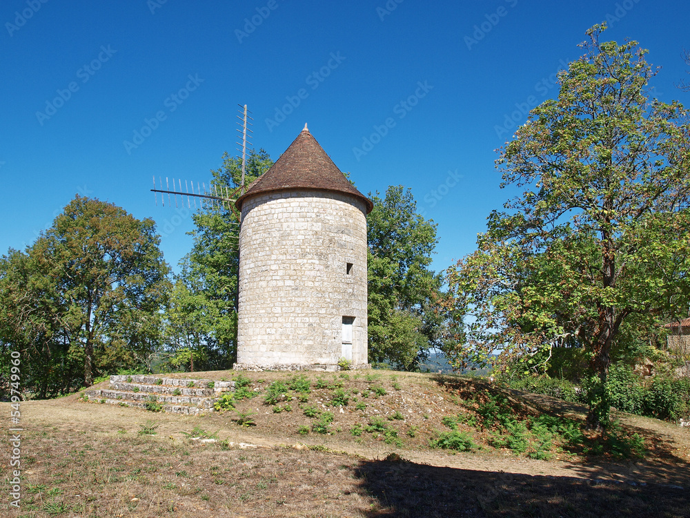Fototapeta premium Royal Bastide of Domme. Roy's windmill (Moulin du Roy' at the end of the Public Garden above the old ramparts of Domme Vieille above the Dordogne Valley and the village of Cenac