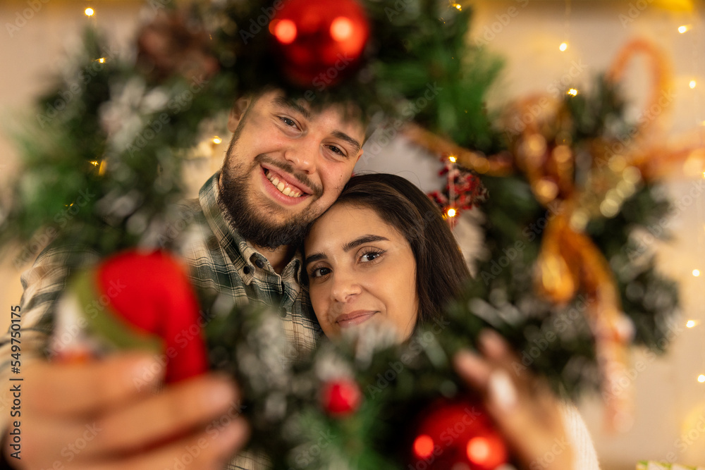 couple decorating christmas tree