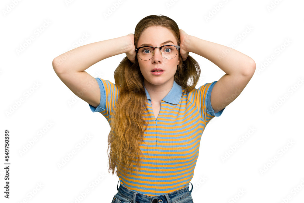 Young caucasian redhead woman isolated covering ears with hands trying not to hear too loud sound.