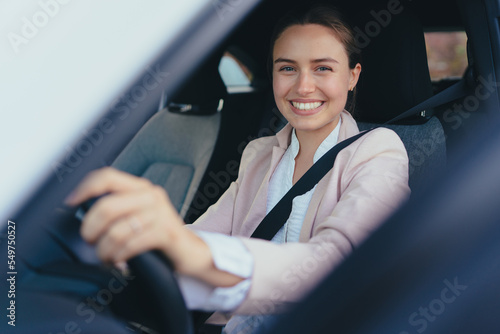 Excited young woman sitting in her car, prepared for driving. © Halfpoint
