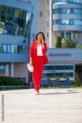 Happy business woman calling by phone