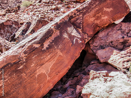 Petroglyph in Petrified Forest, Namibia, Africa.African animals are represented on the stone by ancient men.ancestral artworks are immortalized on red stone blocks