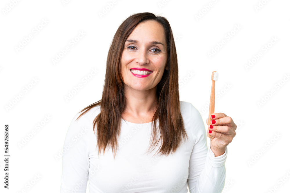 Middle age woman brushing teeth over isolated chroma key background smiling a lot Middle age woman brushing teeth over isolated chroma key background smiling a lot