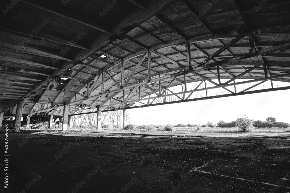 Metal structures old, abandoned aircraft hangar in black and white photo. Metal structures old, abandoned aircraft hangar in black and white photo.